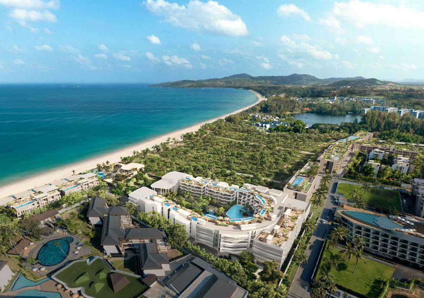 Garrya Residences Phuket | A coastal resort with multiple buildings, pools, and palm trees sits beside a long sandy beach and calm blue sea.