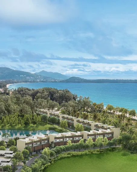 Banyan Tree Grand Residences Beach Terraces - A luxurious balcony at sunset, featuring seating, an infinity pool, overlooking a tropical ocean horizon with palm trees.